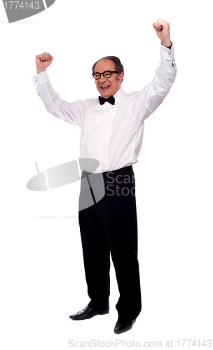 Image of Excited senior man posing with raised arms