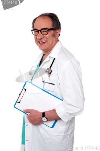 Image of Senior male doctor holding blank clipboard