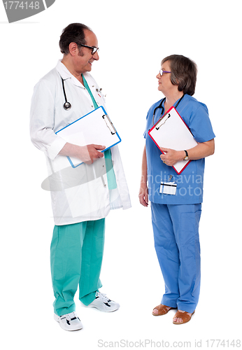 Image of Male and female doctors discussing a case