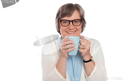 Image of Smiling lady drinking hot coffee