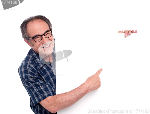 Image of Man pointing at white blank poster