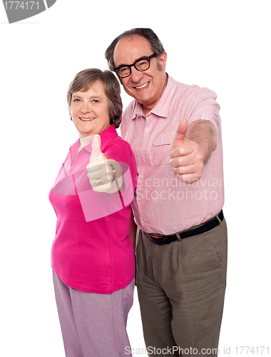 Image of Senior couple gesturing thumbs up
