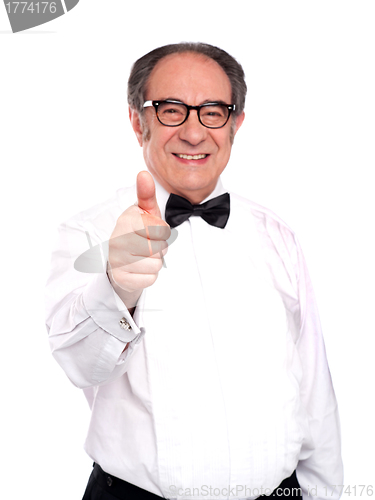 Image of Smiling old man gesturing thumbs up