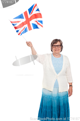 Image of Senior lady holding UK flag and waving