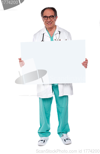 Image of Confident doctor showing blank whiteboard