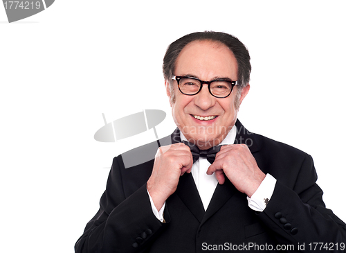 Image of Cheerful old man in classical tuxedo