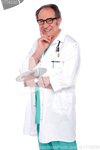 Image of Senior male doctor posing against white