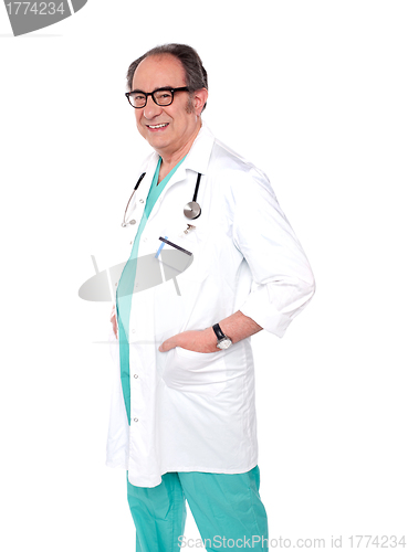 Image of Smiling aged doctor posing in style