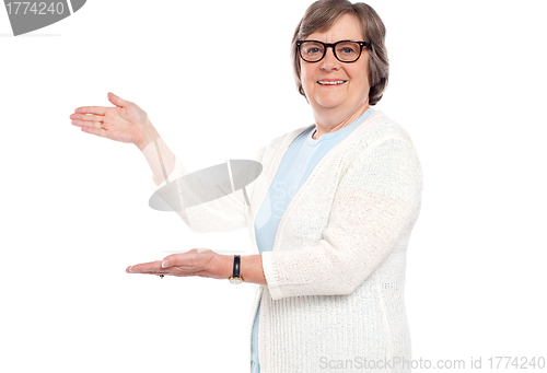 Image of Smiling female presenting copy space. Portrait