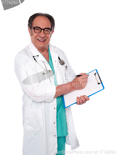 Image of Senior surgeon writing medical report