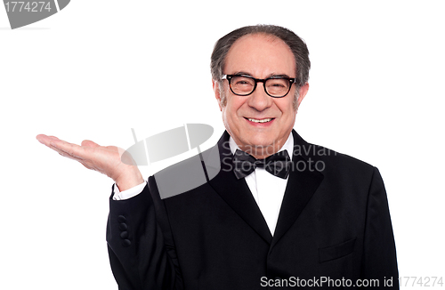Image of Man in party wear presenting copy space