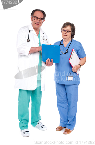Image of Doctor and nurse analyzing report together
