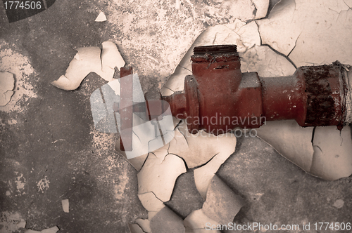 Image of Rusty old tap against concrete wall