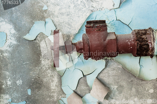 Image of Rusty old tap against concrete wall