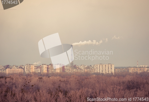 Image of Big chimney in the middle of a city with sky