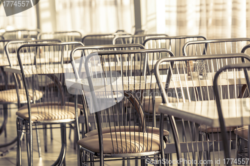 Image of Photo of a canteen with metal chairs and tables