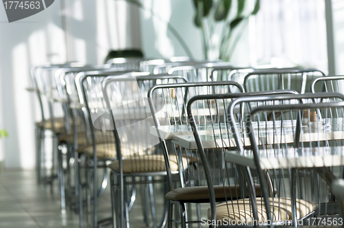 Image of Photo of a canteen with metal chairs and tables