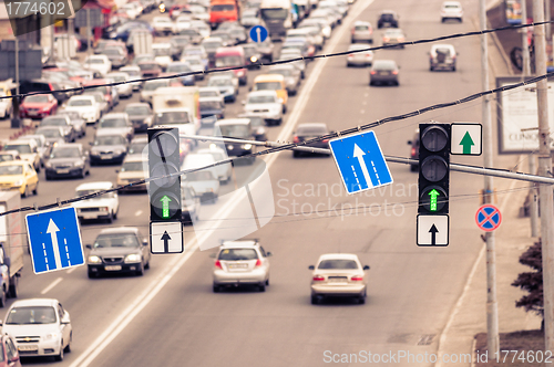 Image of Green traffic lamps and blue sign