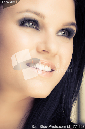 Image of Closeup of a cheerful young woman smiling