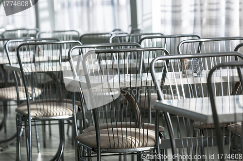 Image of Photo of a canteen with metal chairs and tables