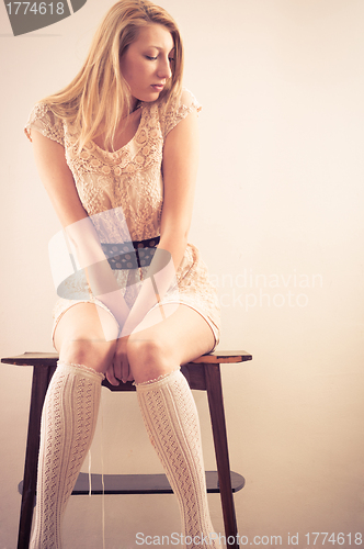 Image of Young woman sitting on chair