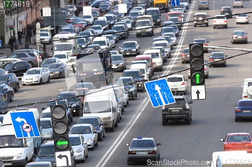 Image of Green traffic lamps and blue sign