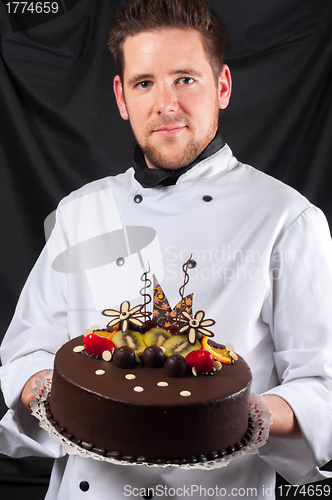 Image of Handsome chef with cake