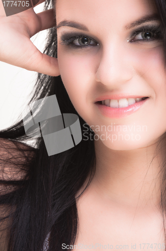 Image of Closeup of a cheerful young woman smiling