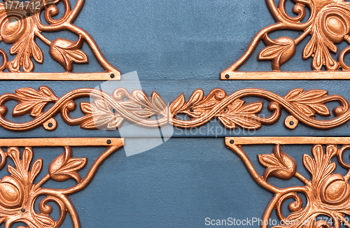 Image of Golden metal lattice on steel background