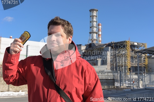 Image of Handsome young explorer and the power plant