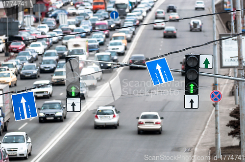 Image of Green traffic lamps and blue sign