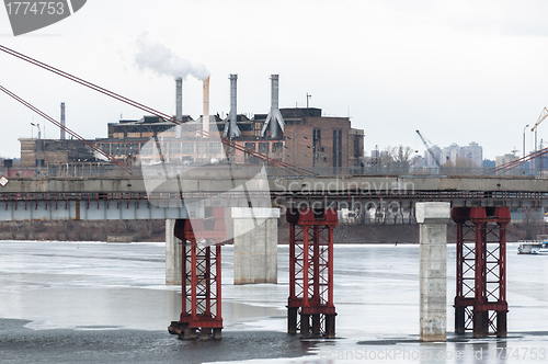 Image of Big industrial chimney in the middle of a city