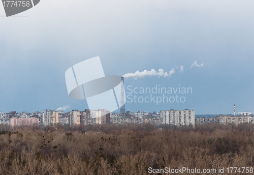 Image of Big chimney in the middle of a city with sky
