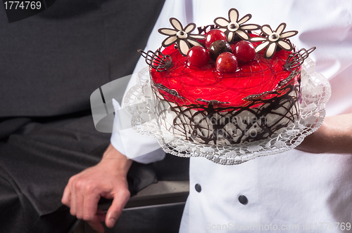 Image of Confectioner holding delicious cake
