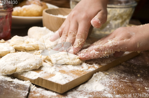 Image of Detail of hands kneading dough