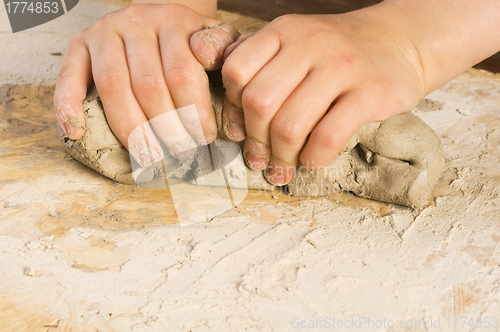 Image of Child hands of a potter