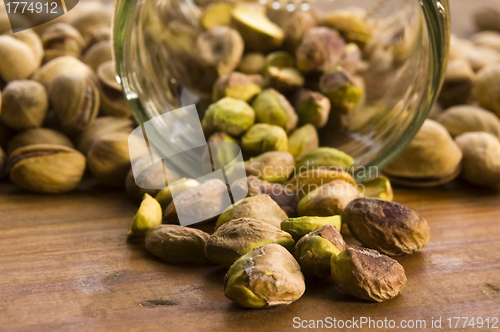 Image of Roasted pistachios on natural wooden table