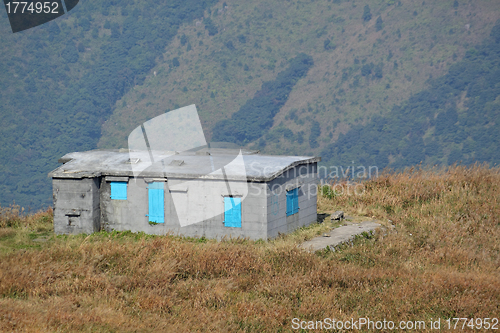 Image of old stone house with grass on the mountain 