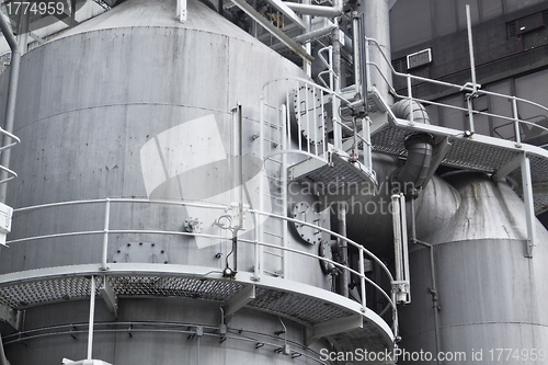 Image of Pipes, tubes, machinery and steam turbine at a power plant 