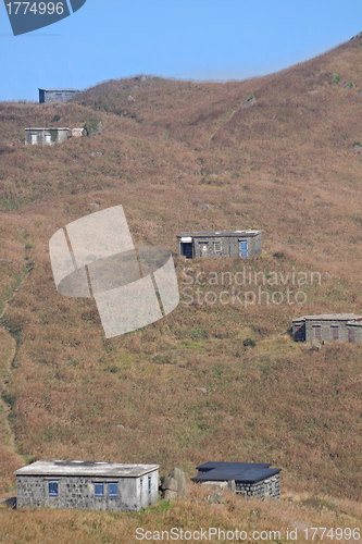 Image of old stone house with grass on the mountain 