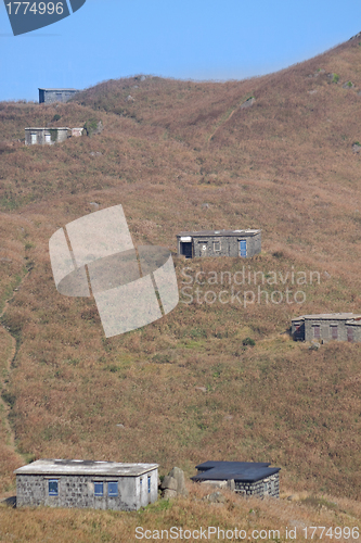 Image of old stone house with grass on the mountain 