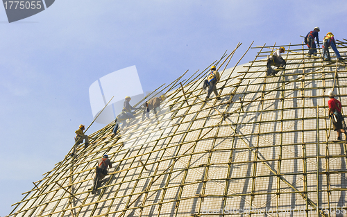 Image of Closeup of construction worker assembling scaffold on building s