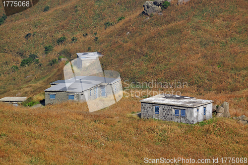 Image of old stone house with grass on the mountain 