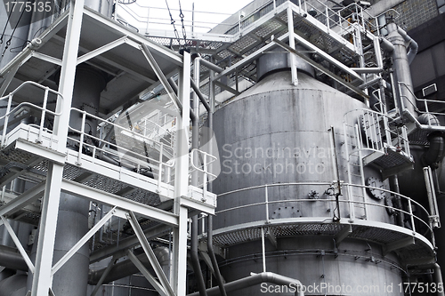 Image of Pipes, tubes, machinery and steam turbine at a power plant 