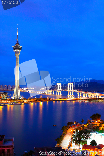 Image of Cityscape in night with famous travel tower near river in Macao,