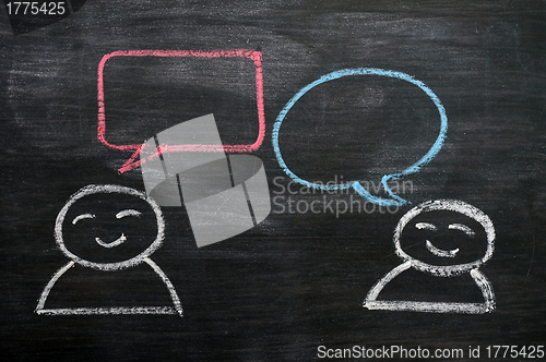 Image of Blank speech bubbles with cartoon figures drawn on a blackboard background