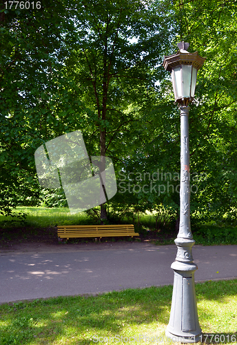 Image of Vintage retro park lamp pole and wooden bench 