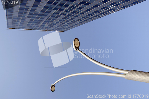 Image of High glass building and street lights in blue sky 