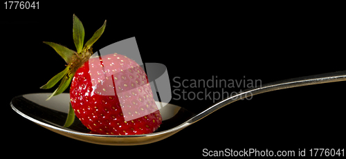 Image of red,fresh strawberry on spoon