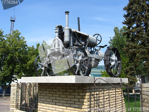 Image of Ancient tractor on a pedestal